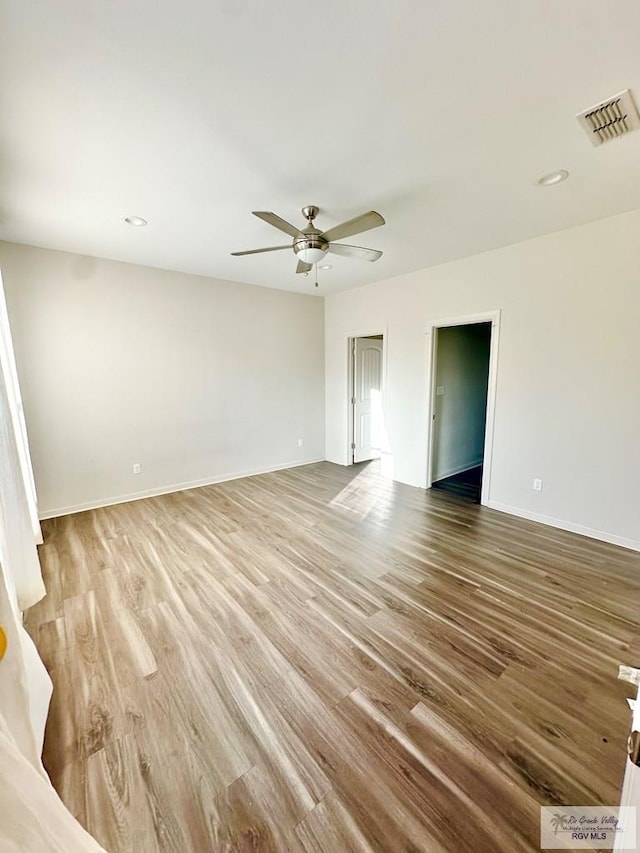 unfurnished room with light wood-type flooring and ceiling fan