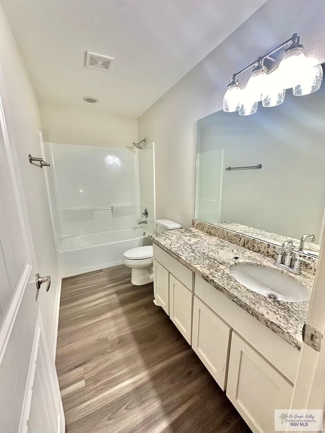 full bathroom with toilet, vanity, shower / bath combination, and wood-type flooring