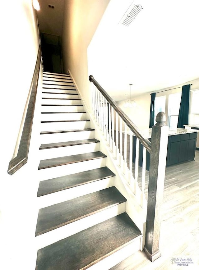 staircase with wood-type flooring