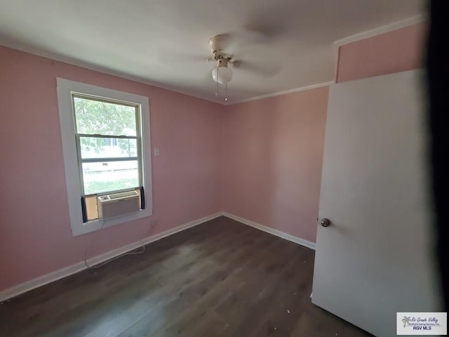 spare room featuring dark wood finished floors, cooling unit, baseboards, and ceiling fan