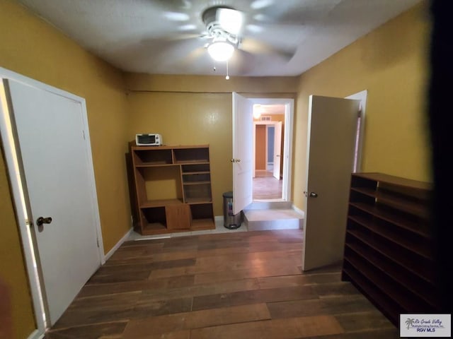 hall featuring baseboards and wood finished floors