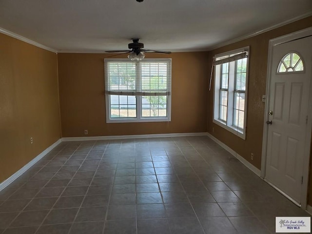 tiled entryway featuring a wealth of natural light, baseboards, ceiling fan, and ornamental molding