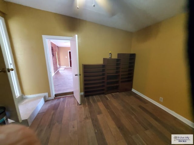 unfurnished bedroom featuring baseboards and wood finished floors