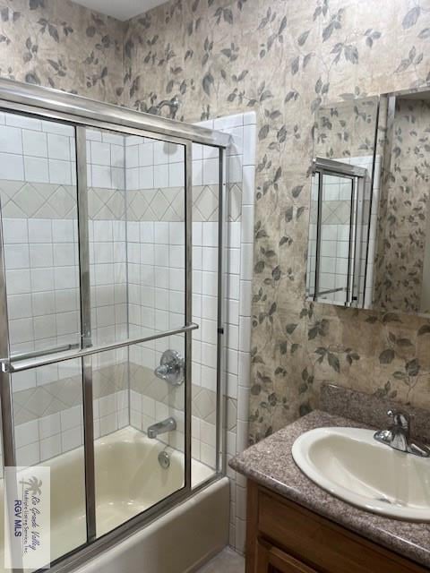 71 Cortez Ave, Rancho Viejo, TX 78575 - full bathroom with shower / bath combination with glass door, vanity, and wallpapered walls