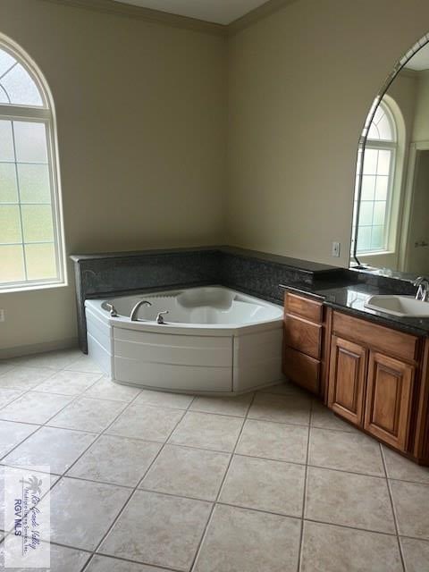 71 Cortez Ave, Rancho Viejo, TX 78575 - full bath featuring vanity, plenty of natural light, tile patterned flooring, a garden tub, and ornamental molding