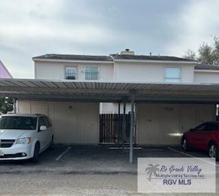 townhome / multi-family property with metal roof, covered parking, and a standing seam roof