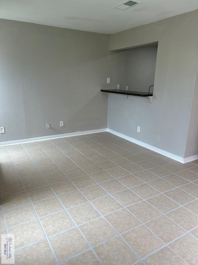 unfurnished room featuring visible vents and baseboards