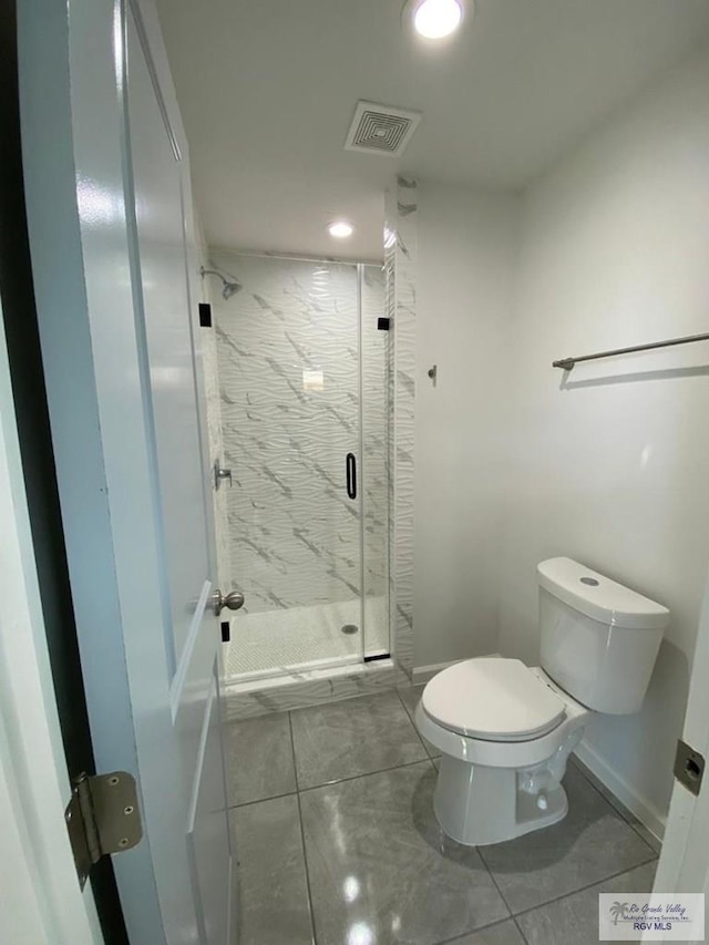 bathroom with an enclosed shower and toilet