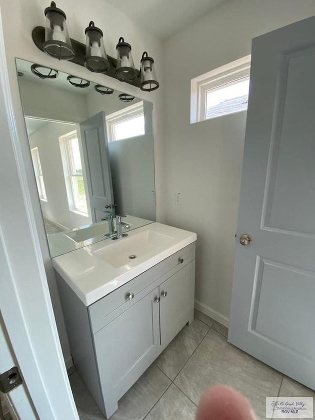 bathroom featuring tile patterned flooring, plenty of natural light, and vanity