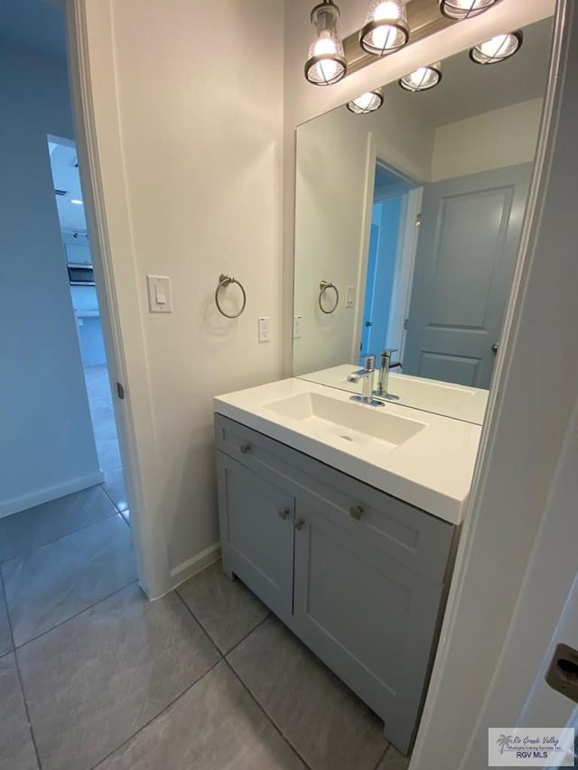 bathroom featuring tile patterned flooring and vanity