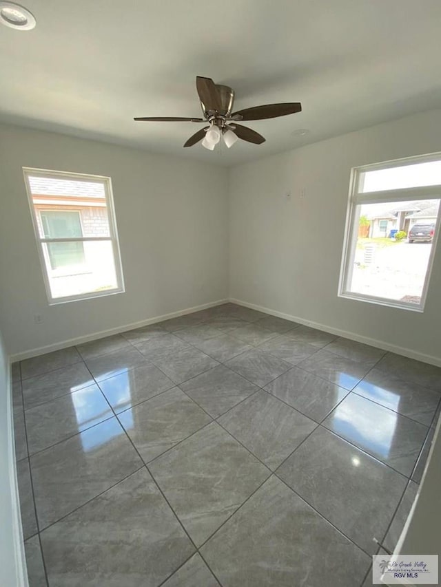 unfurnished room featuring light tile patterned floors, plenty of natural light, and ceiling fan