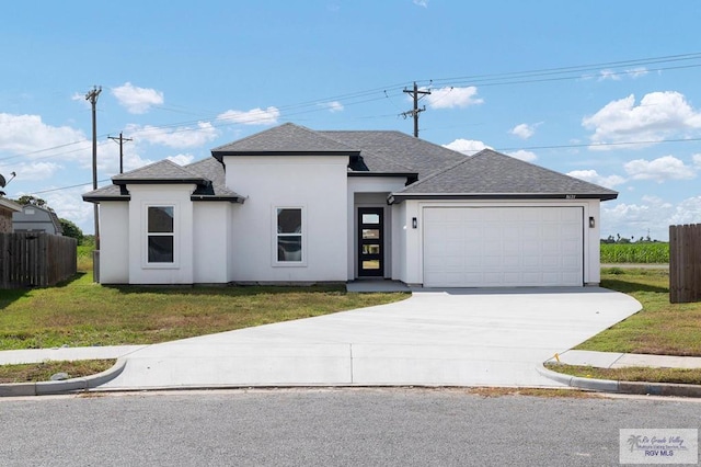 view of front facade featuring a front lawn and a garage