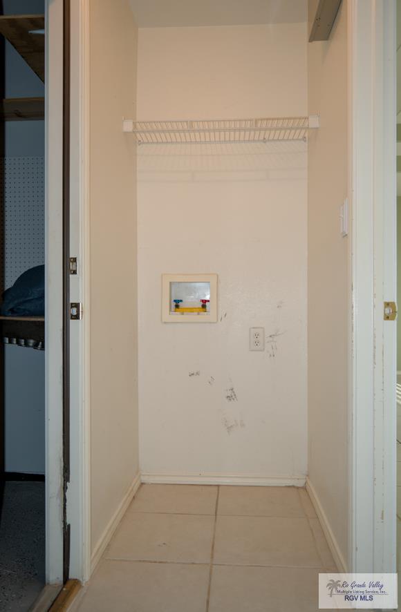 washroom featuring washer hookup and light tile patterned floors