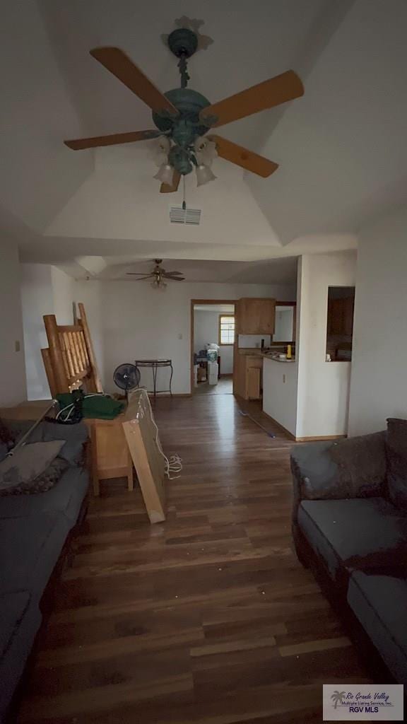 living room with dark hardwood / wood-style flooring and vaulted ceiling