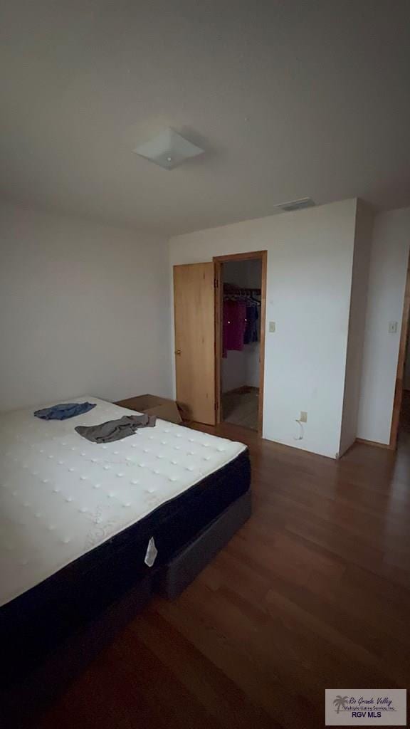 unfurnished bedroom featuring dark hardwood / wood-style flooring