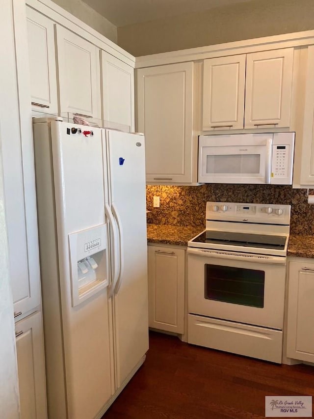 kitchen featuring dark hardwood / wood-style floors, backsplash, dark stone countertops, white appliances, and white cabinets