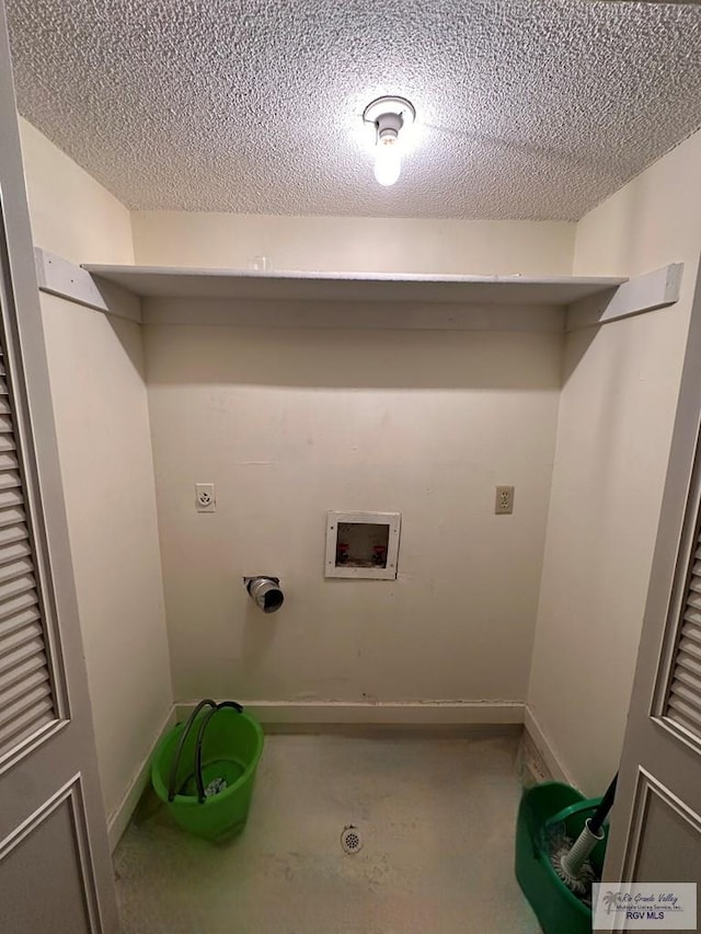 laundry room featuring washer hookup and a textured ceiling