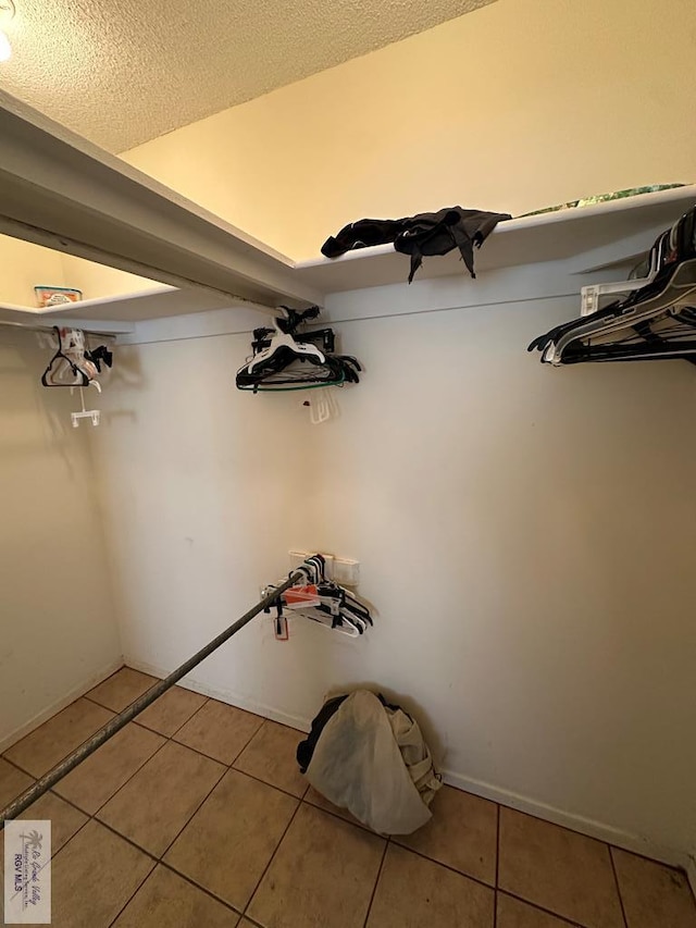 spacious closet featuring light tile patterned floors