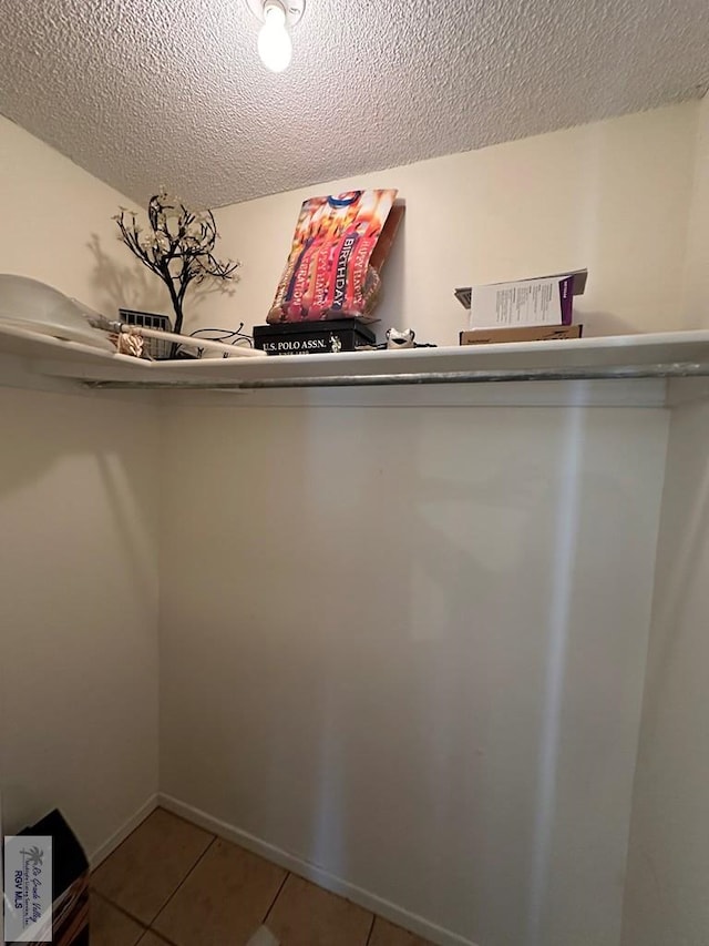 spacious closet with light tile patterned floors