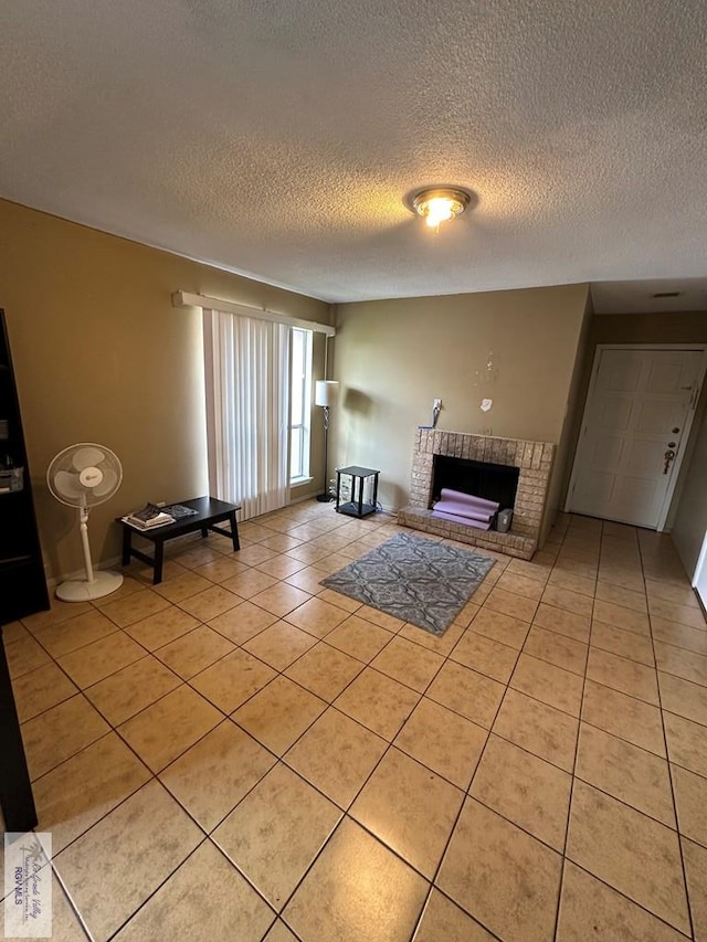 unfurnished living room with a fireplace, light tile patterned floors, and a textured ceiling