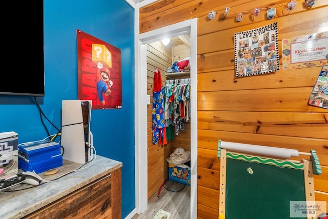 27858 Bixby Rd, La Feria, TX 78559 - bedroom with wooden walls, a closet, and wood finished floors