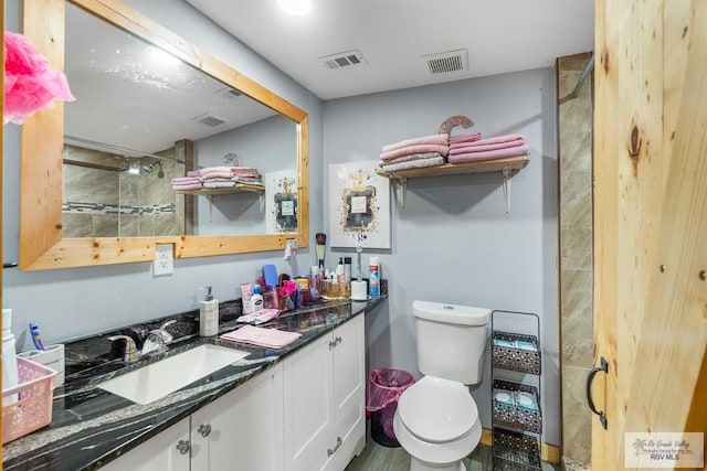 27858 Bixby Rd, La Feria, TX 78559 - bathroom featuring vanity, toilet, and a tile shower