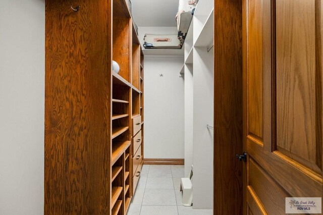 walk in closet featuring light tile patterned floors