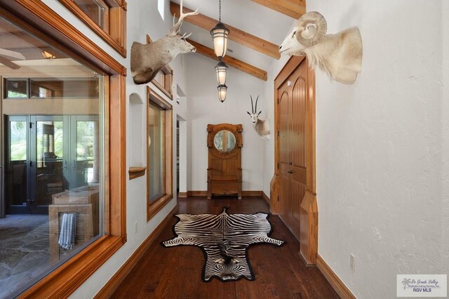 corridor featuring lofted ceiling with beams and dark hardwood / wood-style floors