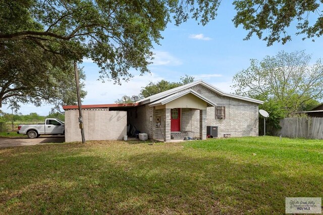 view of front facade with a front lawn and a carport