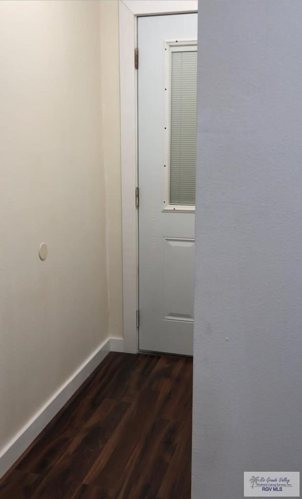 corridor with dark wood-type flooring