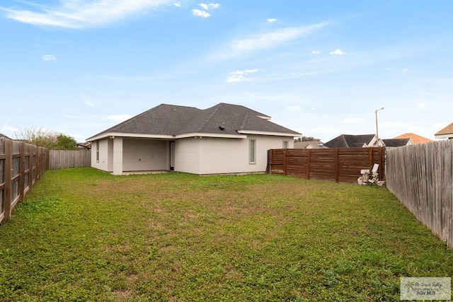 back of property featuring a yard