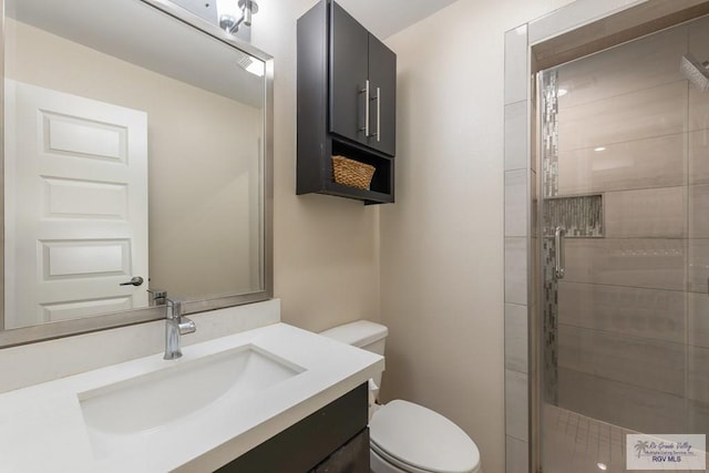 bathroom with vanity, an enclosed shower, and toilet