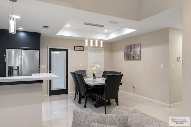 dining area featuring a tray ceiling