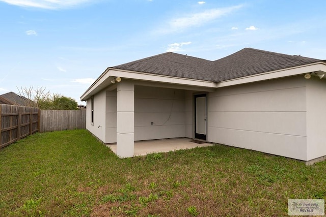 back of property featuring a patio and a lawn