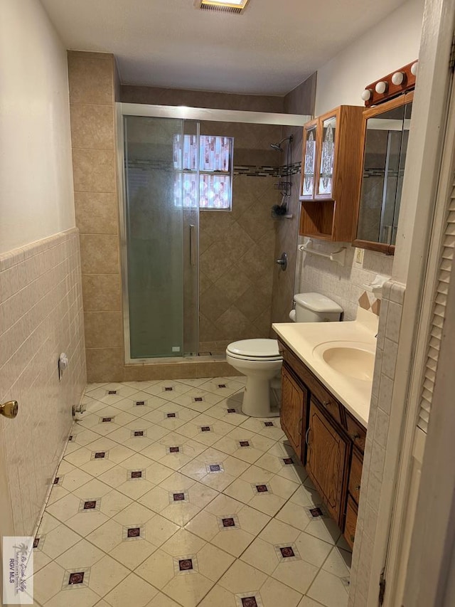 25631 N White Ranch Rd, La Feria, TX 78559 - bathroom with tile patterned flooring, tile walls, vanity, and a shower stall