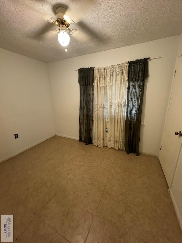 25631 N White Ranch Rd, La Feria, TX 78559 - empty room with ceiling fan and a textured ceiling