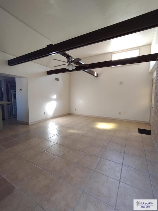 empty room featuring beam ceiling, ceiling fan, and light tile patterned floors