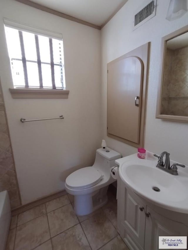 bathroom with vanity, crown molding, tile patterned flooring, a washtub, and toilet