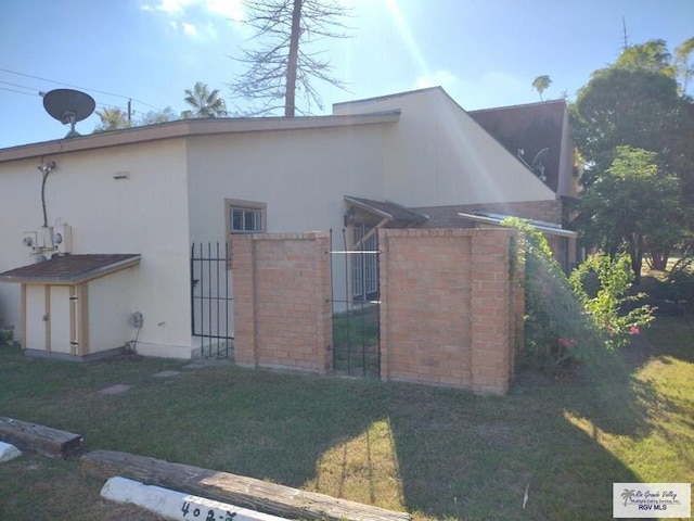 view of side of home with a yard