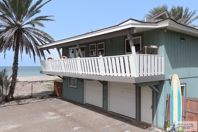 exterior space with a water view and fence