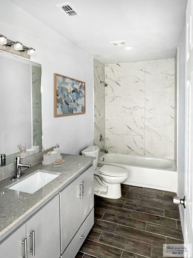 1105 W La Pointe Ave, Alton, TX 78573 - bathroom with vanity, toilet,  shower combination, and wood finish floors