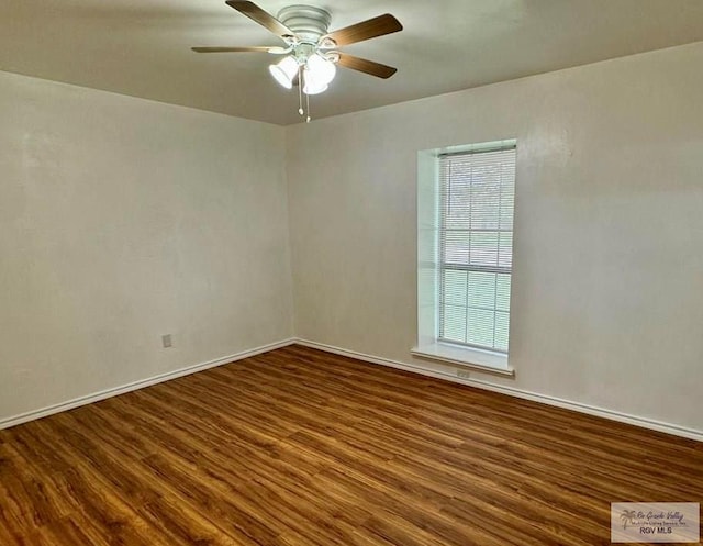 empty room with dark hardwood / wood-style flooring and ceiling fan