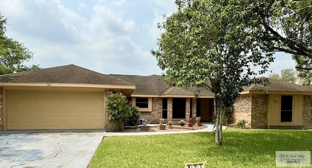 ranch-style home featuring a garage and a front yard