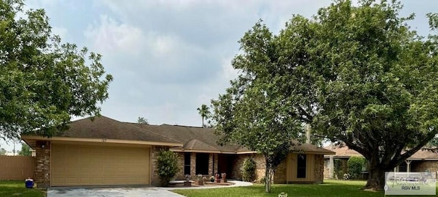 ranch-style house featuring a garage and a front lawn