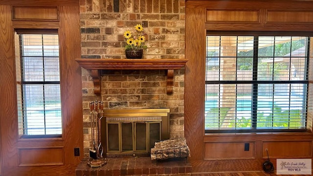 interior details with wood walls, a fireplace, and hardwood / wood-style floors