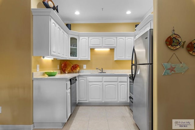 129 E Cora Lee Dr Unit 205, South Padre Island, TX 78597 - kitchen featuring light tile patterned floors, white cabinetry, stainless steel appliances, and light countertops