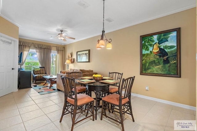 129 E Cora Lee Dr Unit 205, South Padre Island, TX 78597 - dining area featuring light tile patterned floors, baseboards, ornamental molding, and ceiling fan with notable chandelier