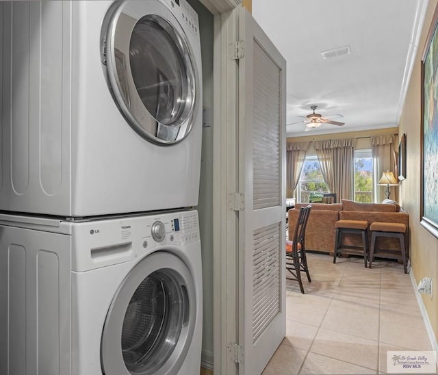 129 E Cora Lee Dr Unit 205, South Padre Island, TX 78597 - clothes washing area with visible vents, stacked washing maching and dryer, light tile patterned flooring, a ceiling fan, and laundry area