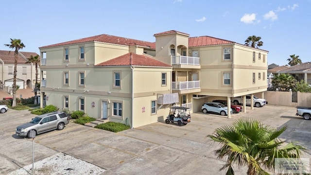 129 E Cora Lee Dr Unit 205, South Padre Island, TX 78597 - view of building exterior with covered parking