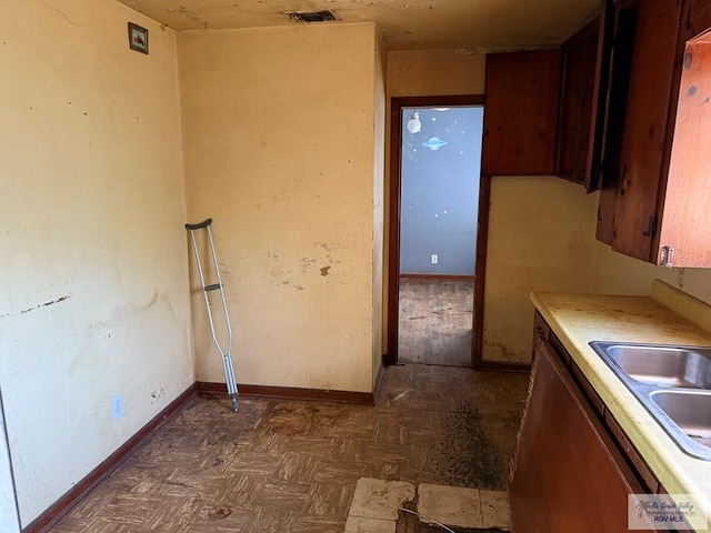 kitchen featuring dark parquet flooring and sink